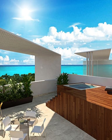 Modern rooftop terrace with wooden deck, white concrete structures, tropical plants, and turquoise ocean view under blue sky